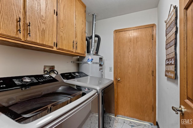 clothes washing area featuring marble finish floor, water heater, cabinet space, and washing machine and clothes dryer