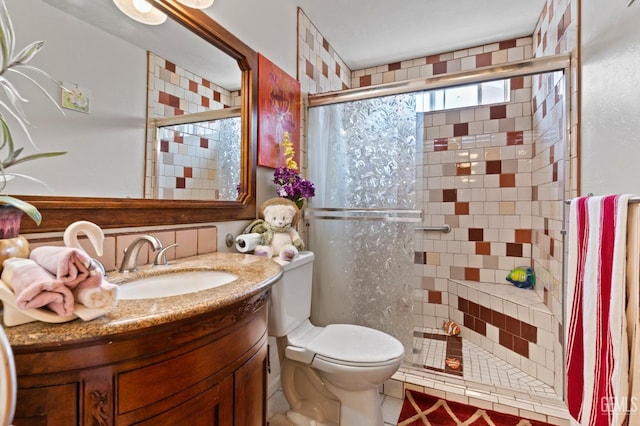 full bath with a shower stall, toilet, and vanity