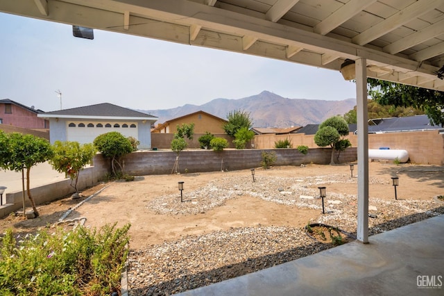 view of yard featuring a fenced backyard and a mountain view