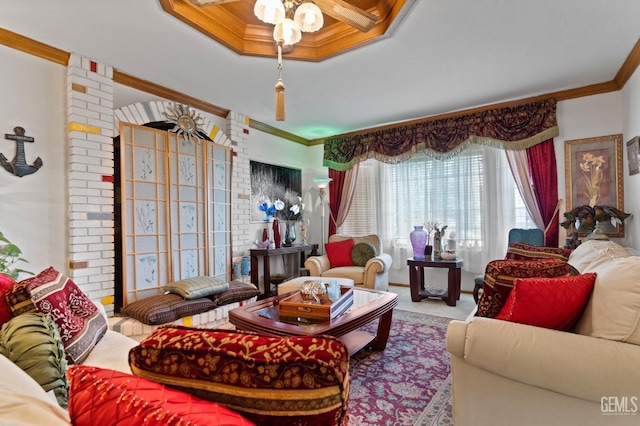 living room with ceiling fan, carpet floors, and crown molding