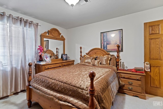 bedroom with visible vents and light colored carpet