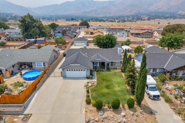 drone / aerial view with a residential view and a mountain view