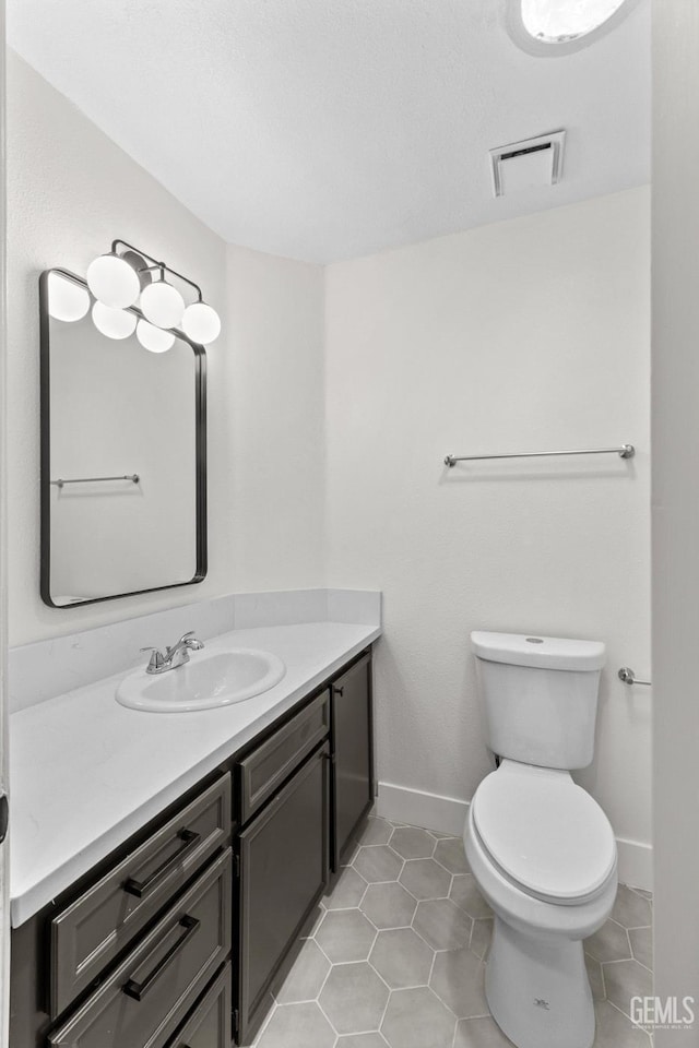 6201 Regina Way, Bakersfield, CA 93307 - bathroom with vanity, toilet, tile patterned floors, and baseboards