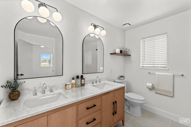 6201 Regina Way, Bakersfield, CA 93307 - bathroom featuring plenty of natural light, toilet, tile patterned floors, and double vanity