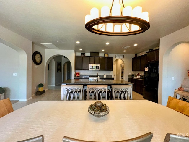 15209 Aldridge Ave, Bakersfield, CA 93314 - dining space featuring arched walkways, recessed lighting, and baseboards