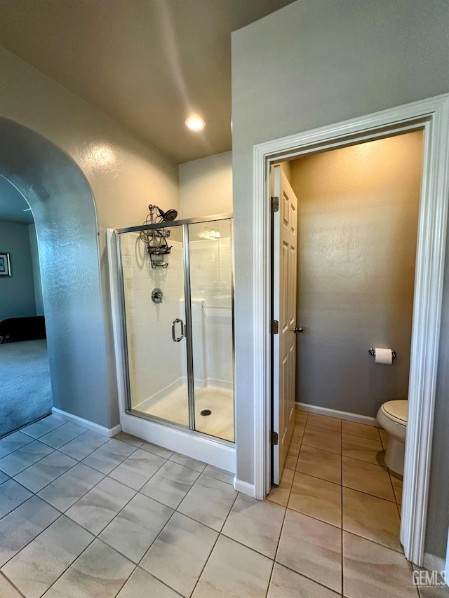 15209 Aldridge Ave, Bakersfield, CA 93314 - bathroom with a shower stall, tile patterned floors, toilet, baseboards, and recessed lighting