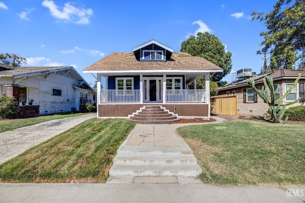 bungalow-style home with a porch and a front yard