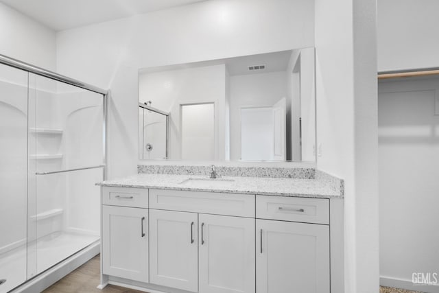 8401 Seth Alexander Way, Bakersfield, CA 93306 - full bath with a shower stall, vanity, and wood finished floors