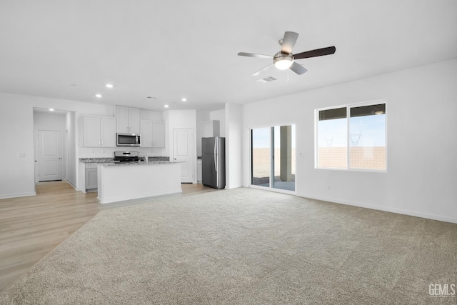 8401 Seth Alexander Way, Bakersfield, CA 93306 - unfurnished living room with a ceiling fan, recessed lighting, and light wood-style floors