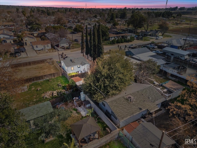 aerial view at dusk featuring a residential view