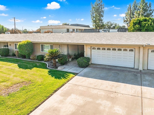 view of front of house with a garage and a front lawn