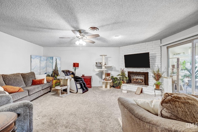 living room featuring carpet flooring, ceiling fan, a textured ceiling, and a brick fireplace