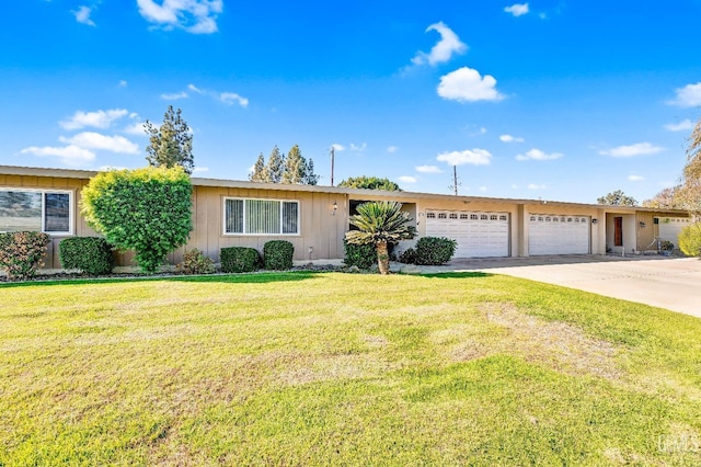 ranch-style home with a garage and a front lawn