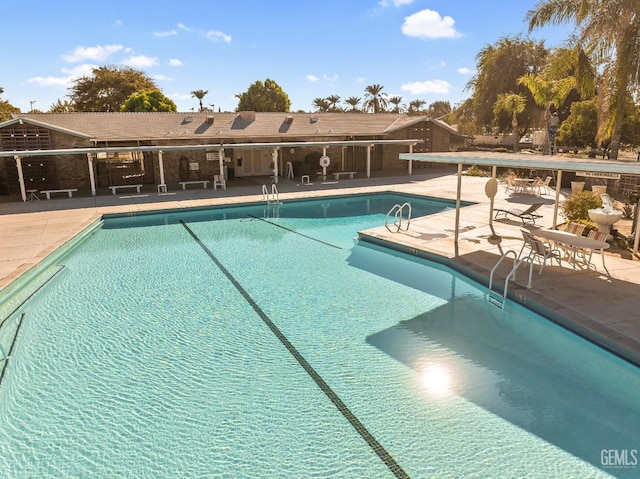 view of swimming pool with a patio area