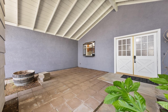 doorway to property featuring a patio and stucco siding