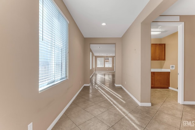 hall featuring light tile patterned floors