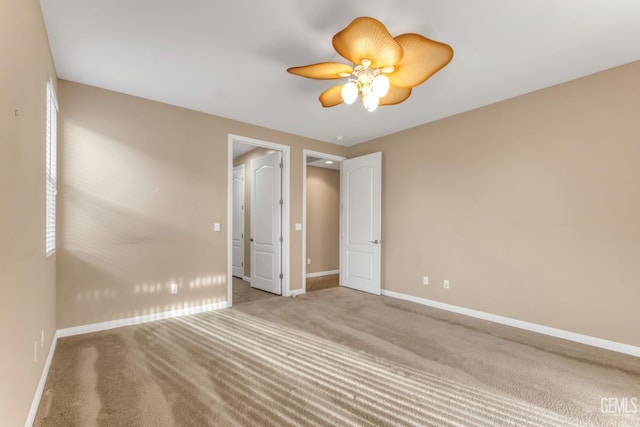 unfurnished room featuring ceiling fan and light colored carpet