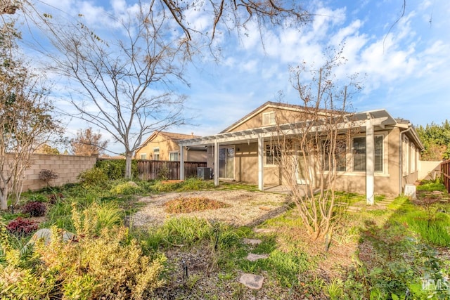 back of house featuring a pergola