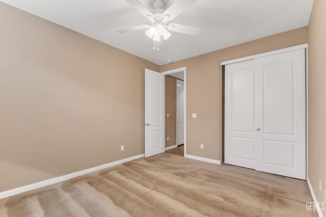 unfurnished bedroom with ceiling fan, light colored carpet, and a closet