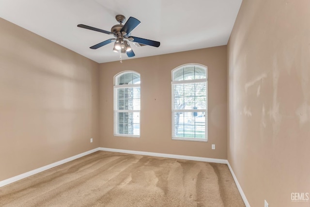 empty room with ceiling fan and carpet