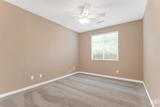 spare room featuring carpet and ceiling fan