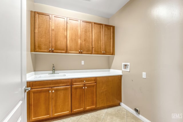 washroom featuring cabinets, hookup for a washing machine, sink, and light tile patterned floors