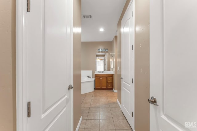 hall featuring light tile patterned floors