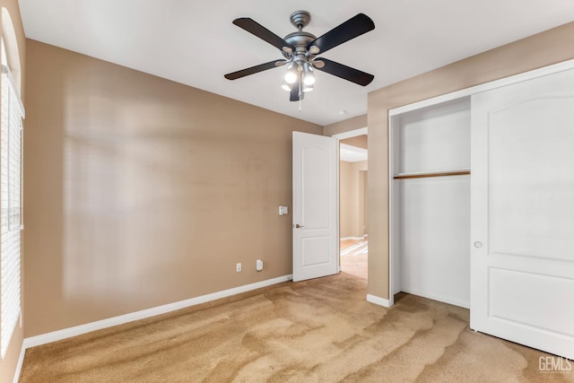 unfurnished bedroom with light colored carpet, a closet, and ceiling fan