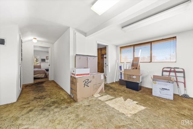 interior space featuring dark colored carpet and lofted ceiling