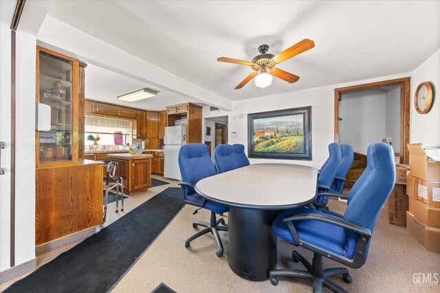 office with ceiling fan and light carpet