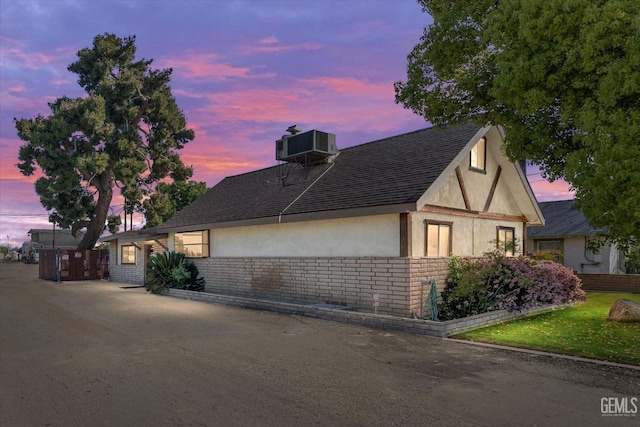 property exterior at dusk with central air condition unit