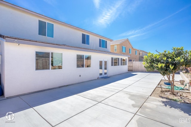 7327 Glitter Way, Bakersfield, CA 93313 - rear view of house with stucco siding and a patio