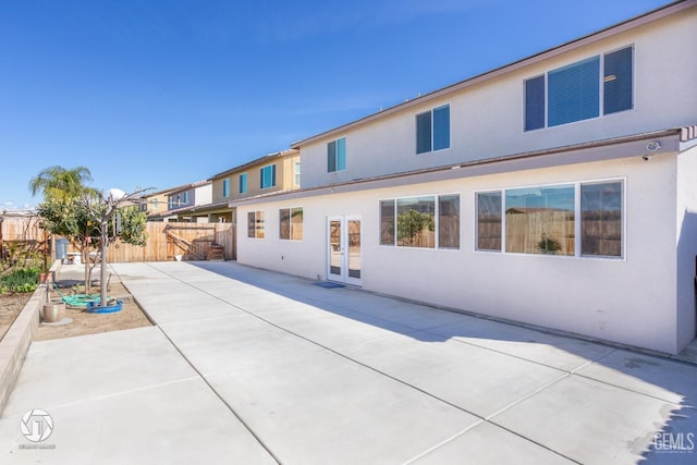 7327 Glitter Way, Bakersfield, CA 93313 - back of house featuring a patio area, stucco siding, and french doors