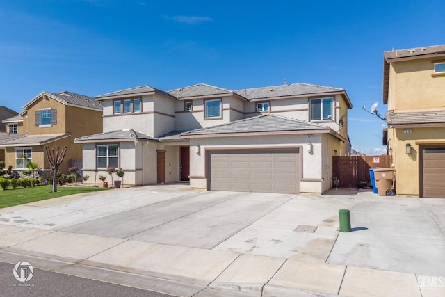 7327 Glitter Way, Bakersfield, CA 93313 - view of front of house featuring driveway, stucco siding, an attached garage, and a residential view