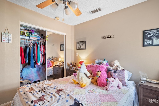 bedroom featuring ceiling fan, a closet, and visible vents