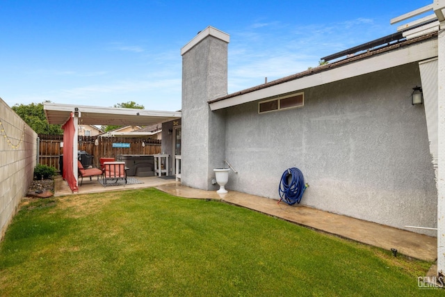 view of yard with a fenced backyard and a patio area