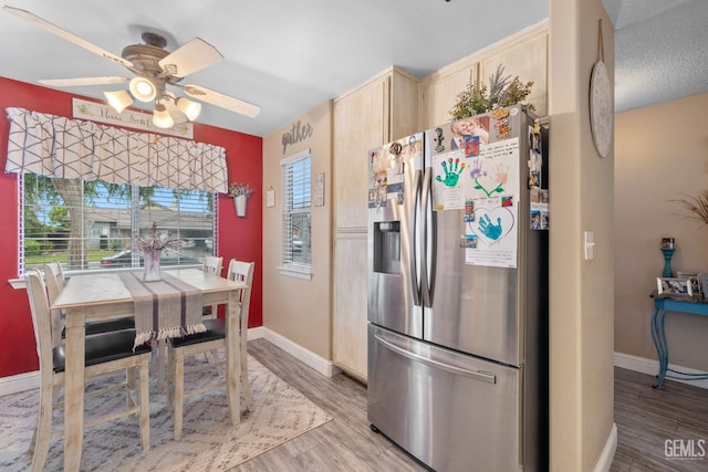 kitchen with a ceiling fan, baseboards, stainless steel fridge with ice dispenser, and light brown cabinets