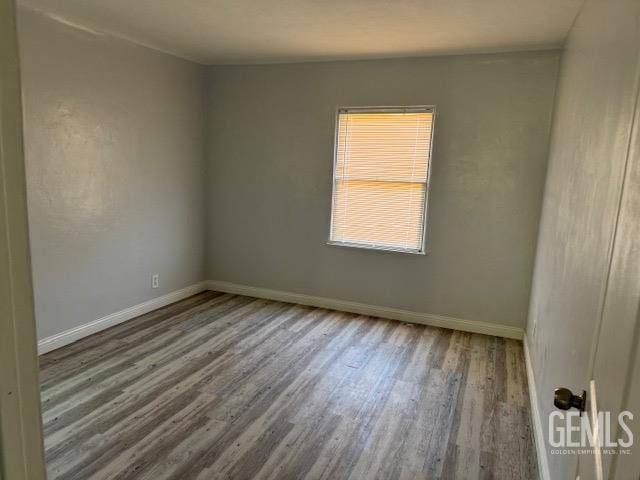 spare room with hardwood / wood-style flooring