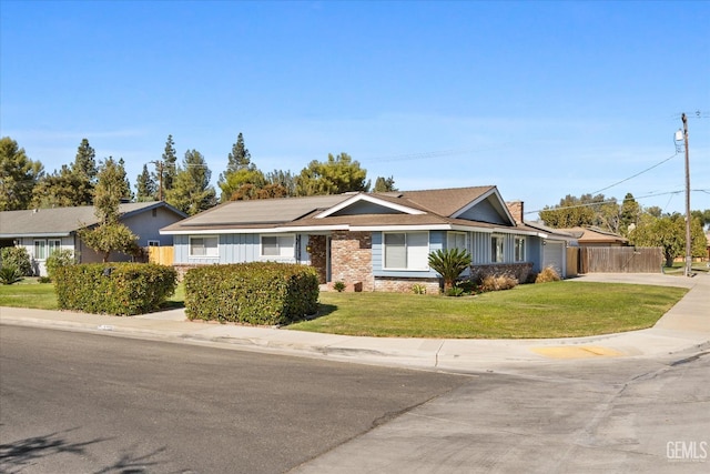 single story home featuring a front yard and solar panels