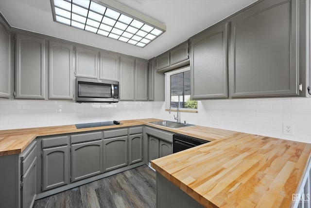 kitchen featuring gray cabinetry, wooden counters, sink, and black appliances