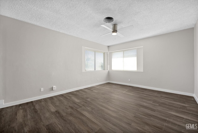 spare room with dark wood-type flooring, a textured ceiling, and ceiling fan