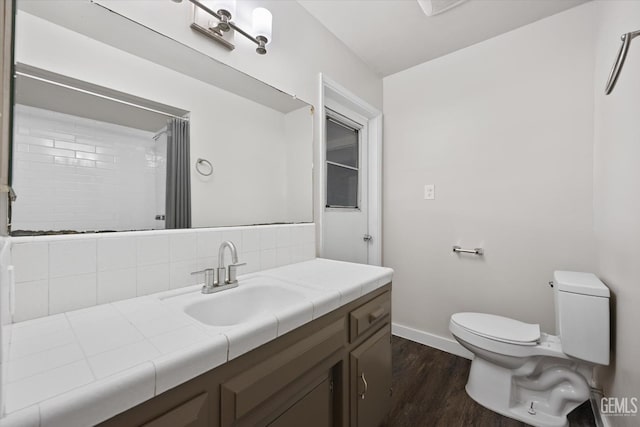 bathroom featuring vanity, hardwood / wood-style floors, curtained shower, and toilet