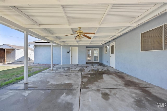 view of patio with ceiling fan and a storage shed