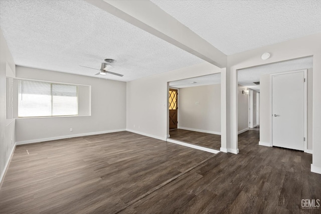 spare room featuring dark hardwood / wood-style floors, a textured ceiling, and ceiling fan