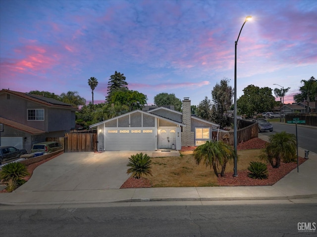 4512 San Miguel Way, Bakersfield, CA 93306 - ranch-style house featuring concrete driveway, a chimney, and an attached garage