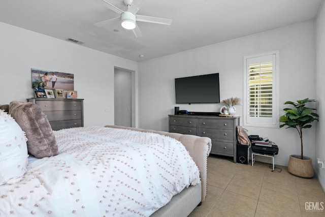 bedroom with light tile patterned floors, visible vents, and ceiling fan