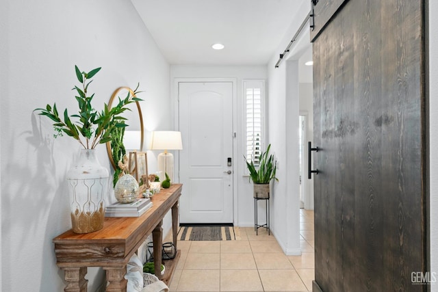 entryway featuring light tile patterned floors and a barn door