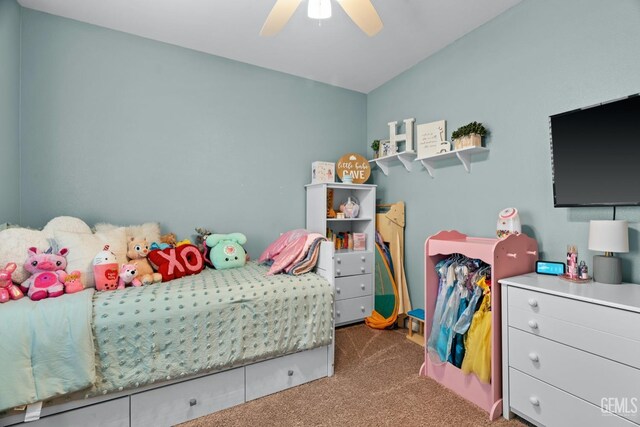 carpeted bedroom with vaulted ceiling and a ceiling fan