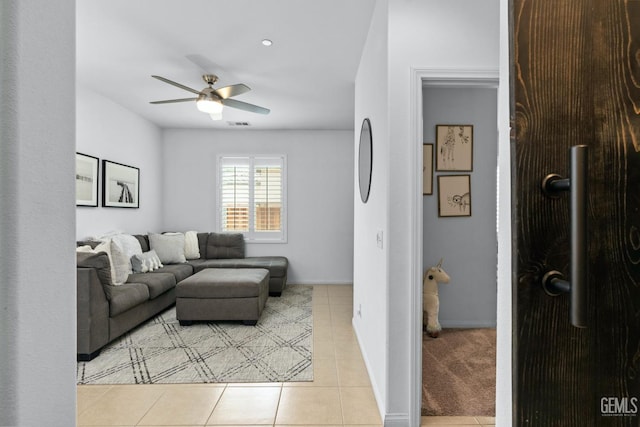 living room with light tile patterned flooring and ceiling fan