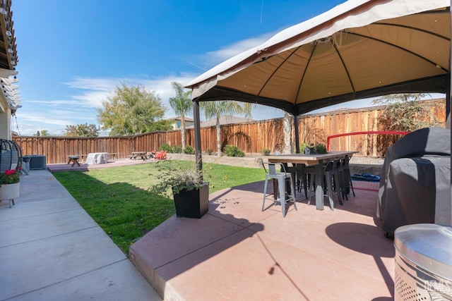 view of patio featuring a gazebo, grilling area, outdoor dining space, and fence